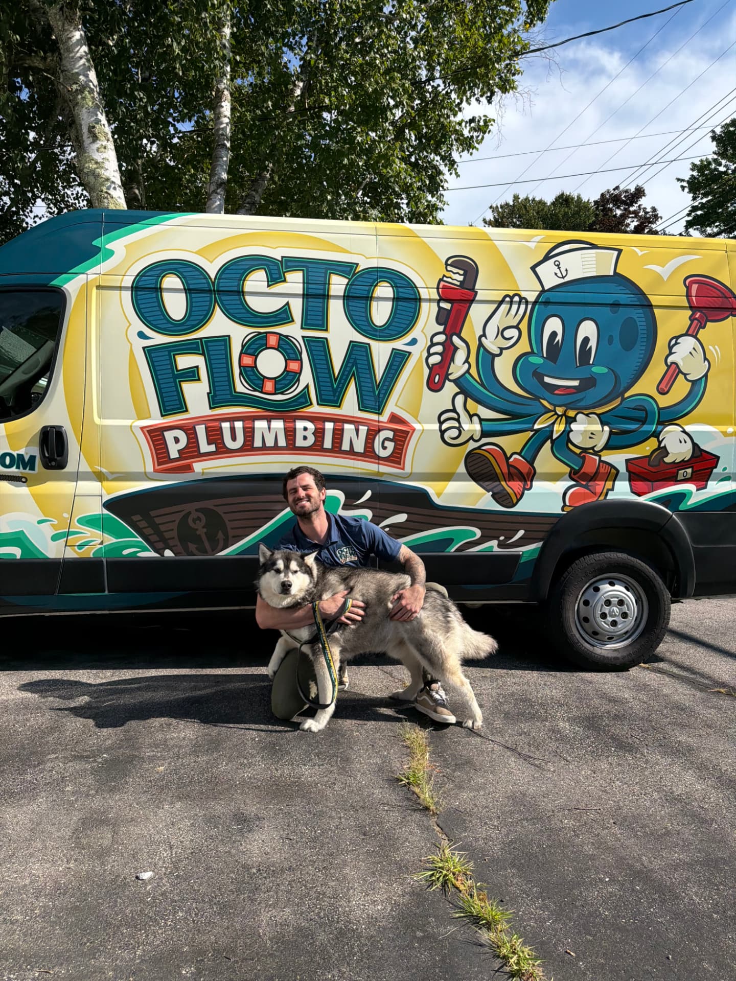 OctoFlow owner with his dog in front of the OctoFlow Plumbing service van